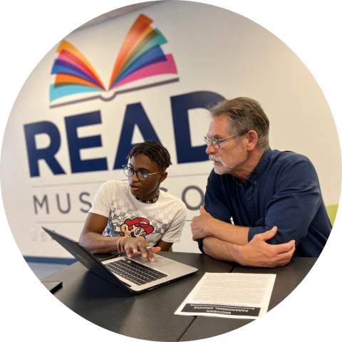 2 individuals looking at a computer at Read Muskegon